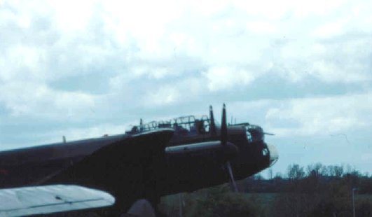 A photograph showing the front of the fusilage as the Lancaster waits on the runway